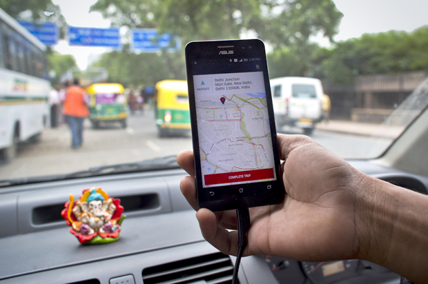 An Indian cab driver displays the city map on a smartphone provided by Uber as he drives in New Delhi, July 31, 2015. (AP/Saurabh Das)