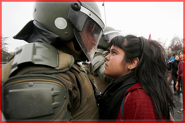 A demonstrator looks at a riot policeman during a protest marking the country's 1973 military coup in Santiago, Chile September 11, 2016. REUTERS/Carlos Vera FOR EDITORIAL USE ONLY. NO RESALES. NO ARCHIVE.     TPX IMAGES OF THE DAY      - RTSN9Z3 (Reuters)