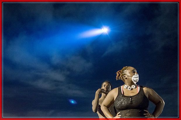 CHARLOTTE, NC - SEPTEMBER 23: Demonstrators take a break from marching as a helicopter flies above on September 23, 2016 in Charlotte, NC. Protests began on Tuesday night following the fatal shooting of 43-year-old Keith Lamont Scott at an apartment complex near UNC Charlotte. A state of emergency was declared overnight in Charlotte and a midnight curfew was imposed by mayor Jennifer Roberts, to be lifted at 6 a.m. Despite a midnight curfew, police allowed the peaceful march to continue without interference.  (Photo by Sean Rayford/Getty Images) (Getty Images)