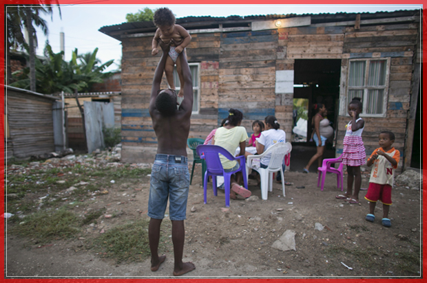 A little baby is raises by a boy in a neighborhood in Cartagena, Colombia, Sunday, Sept. 25, 2016. Colombia's government and the Revolutionary Armed Forces of Colombia, FARC, will sign a peace agreement to end over 50 years of conflict, in Cartagena, on Monday. (AP Photo/Ariana Cubillos) (AP)