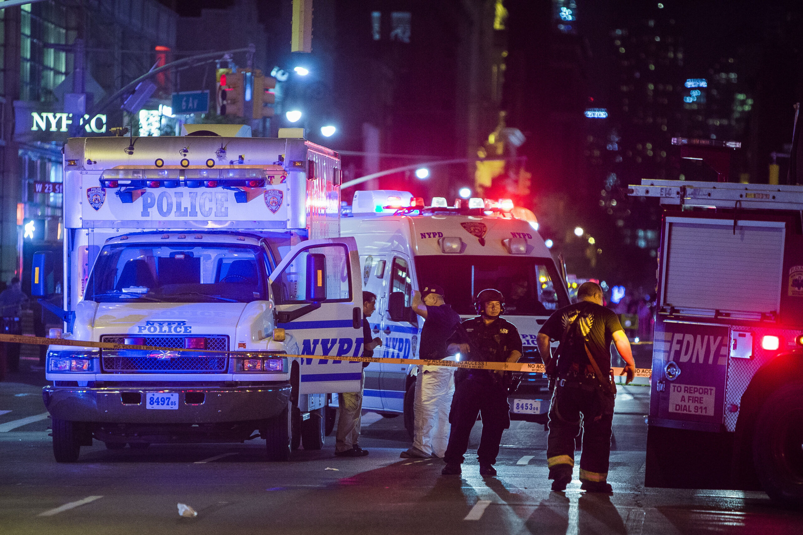 Police and firefighters work near to the scene in Manhattan, New York, Saturday, Sept. 17, 2016. Police and firefighters are at the scene of an apparent explosion in New York City, and authorities say 25 people suffered minor injuries. Police spokesman J. Peter Donald said on Twitter that the explosion happened at about 8:30 p.m. Saturday on West 23rd Street in the Chelsea section of Manhattan. (AP Photo/Andres Kudacki) (AP)