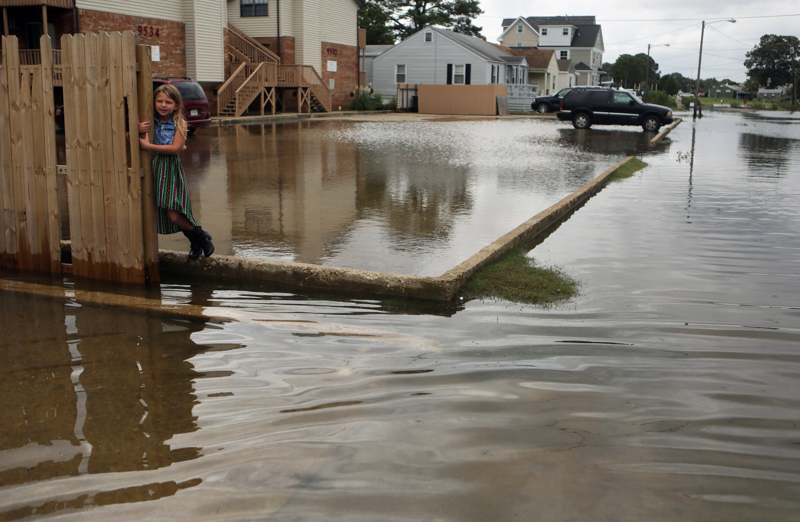 Chloe Riffle, 7, watches as she is surrounded by water on Sunday, Sept. 4, 2016 in the Ocean View section of Norfolk, Va.  Storm system Hermine spun away from the U.S. East Coast on Sunday, removing the threat of heavy rain but maintaining enough power to churn dangerous waves and currents  and keep beaches off-limits to disappointed swimmers and surfers during the holiday weekend.  (Vicki Cronis-Nohe /The Virginian-Pilot via AP) (AP)