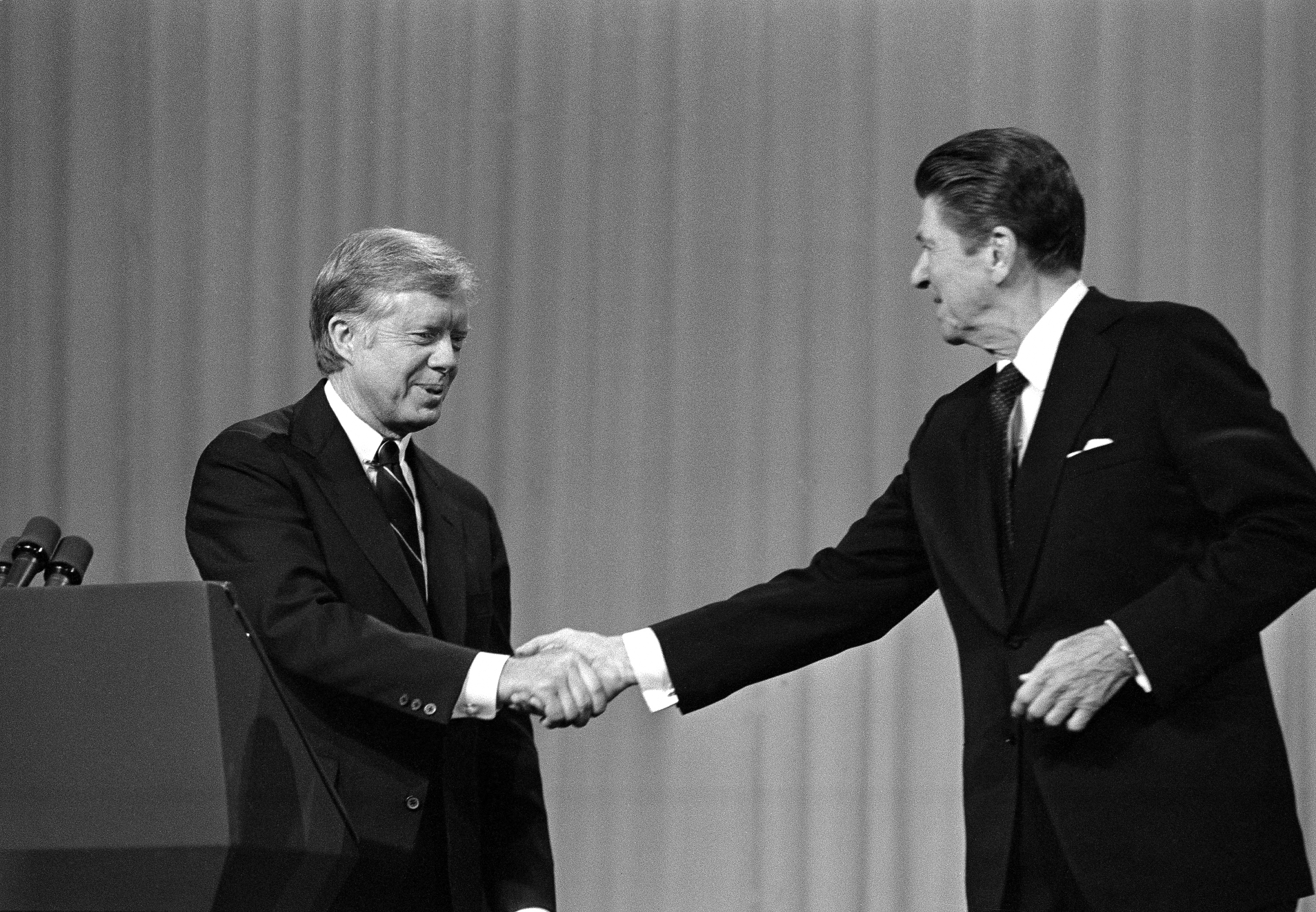ADVANCE FOR MONDAY, SEPT. 5 AND THEREAFTER -FILE - In this Oct. 28, 1980 file photo, President Jimmy Carter shakes hands with Republican Presidential candidate Ronald Reagan after debating in the Cleveland Music Hall in Cleveland. (AP)