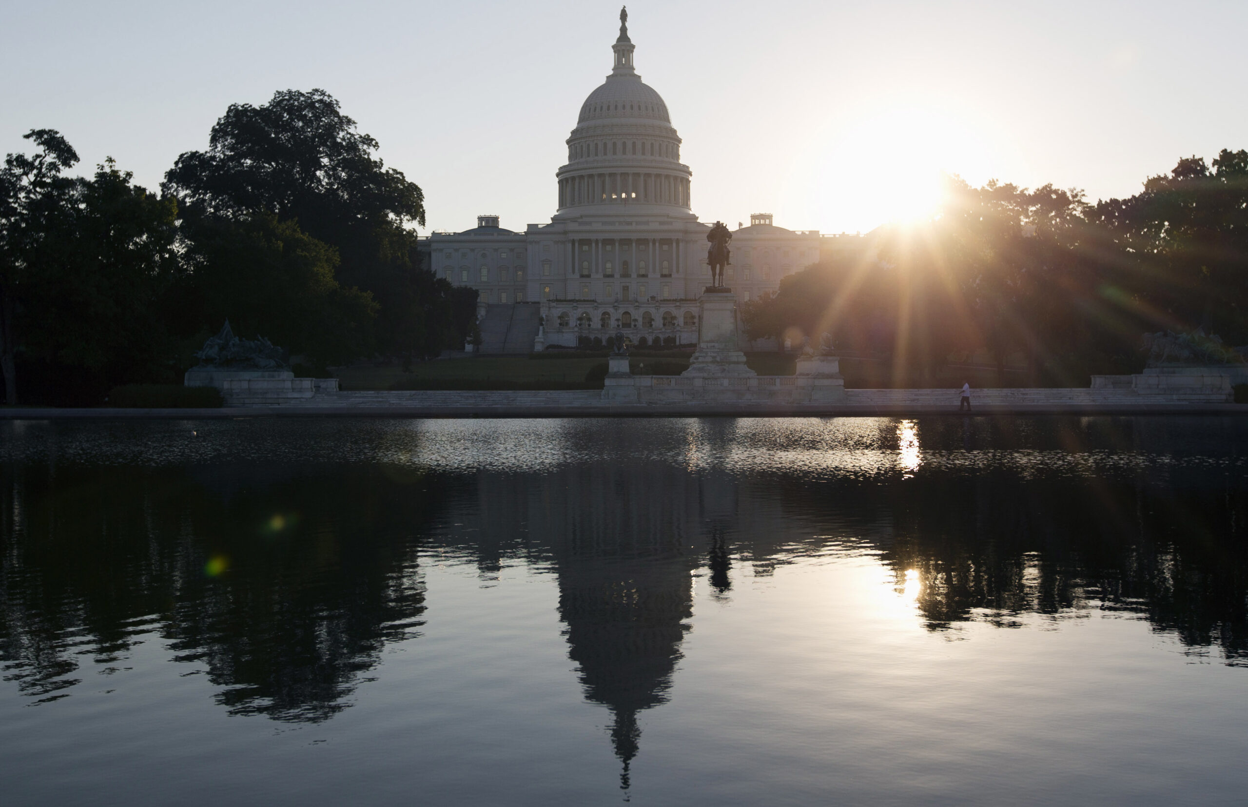 This Wednesday, Oct. 2, 2013 photo shows the Capitol building reflected in the Capitol Reflecting Pool at sunrise in Washington. The 2016 presidential campaign has underscored an economic paradox: Financially, black Americans and Hispanics are far worse off than whites, yet polls show minorities are more likely than whites to believe in the American Dream. And they are less anxious about the outcome of the election. (AP Photo/Carolyn Kaster) (AP)
