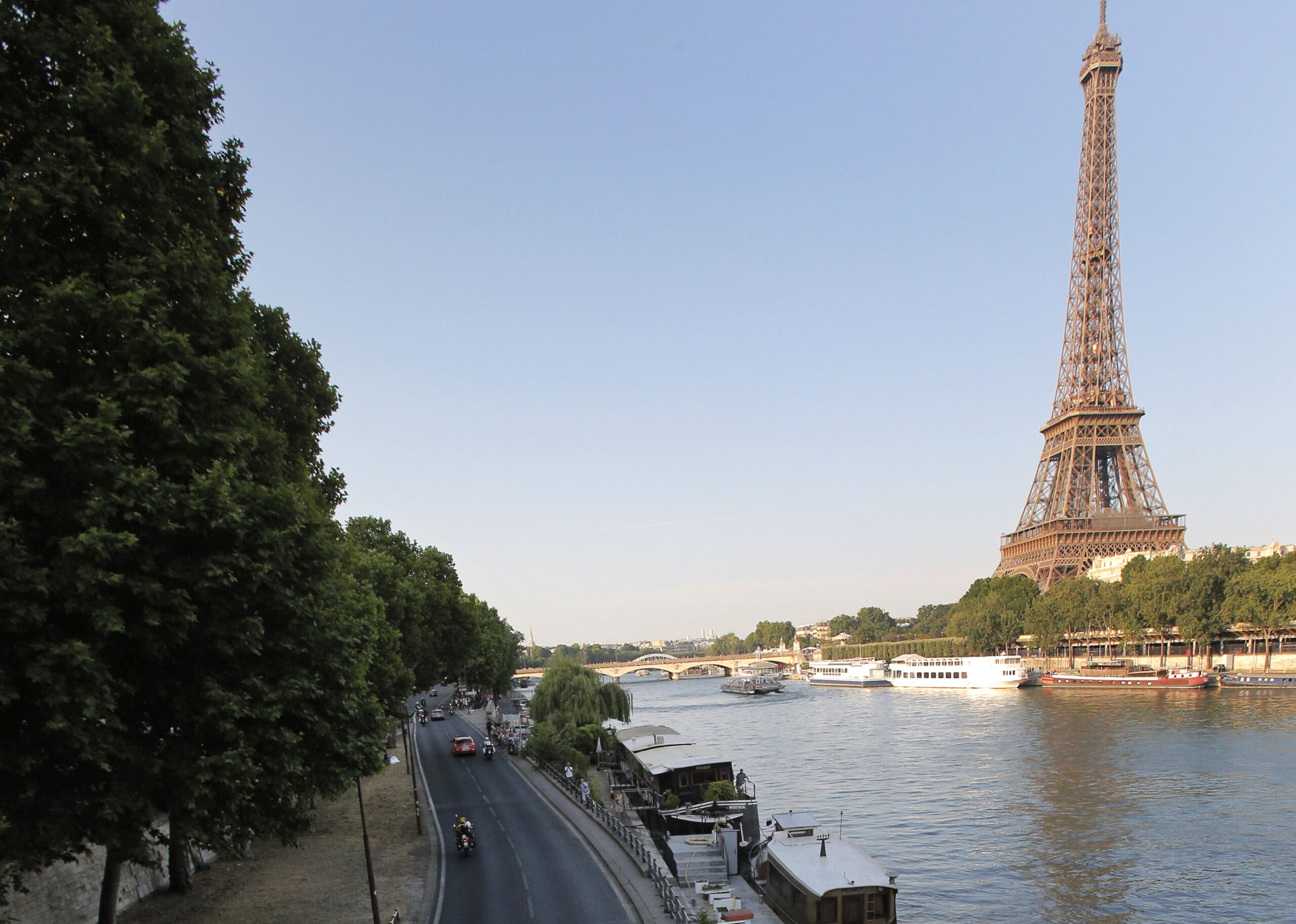 FILE - In this July 21, 2013 file photo shows the road along the Seine river, with the Eiffel Tower at right, in Paris. Paris City Hall has approved Monday Sept.26, 2016 a controversial plan to close down a stretch of highway that runs along the Seine River through central Paris and transform it into a pedestrian zone. It's part of Mayor Anne Hidalgo's push to fight Paris' exceptionally high pollution. (AP Photo/Christophe Ena, File) (AP)