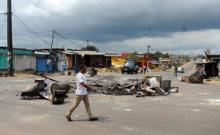 A man walk past a barricade following an election protest in Libreville, Gabon, Thursday Sept. 1, 2016. Gabon's newly re-elected president sought to assert authority Thursday as the presidential guard attacked the opposition candidate's party headquarters overnight, killing at least one person and injuring more than a dozen amid fiery protests that have seen hundreds detained and the internet blocked. (AP Photo/Joel Bouopda) (AP)