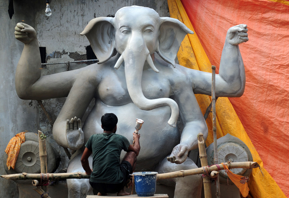 An Indian artisan puts the finishing touches of paint on an idol of elephant-headed Hindu God Ganesh ahead of the Ganesh Chaturthi festival in Allahabad on September 1, 2016. 
The popular eleven-day long Hindu religious festival, Ganesh Chaturthi will be celebrated from September 5-15. / AFP / SANJAY KANOJIA        (Photo credit should read SANJAY KANOJIA/AFP/Getty Images) (Afp/getty Images)