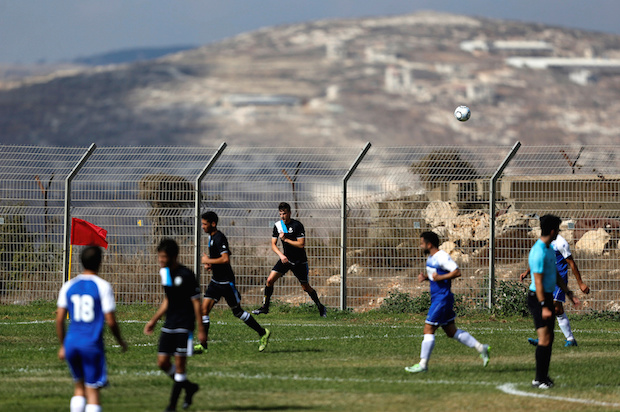 Players from Israeli soccer clubs affiliated with the Israel Football Association play against each other at training grounds in the illegal West Bank settlement of Ariel, on September 23, 2016 (Reuters/Amir Cohen)