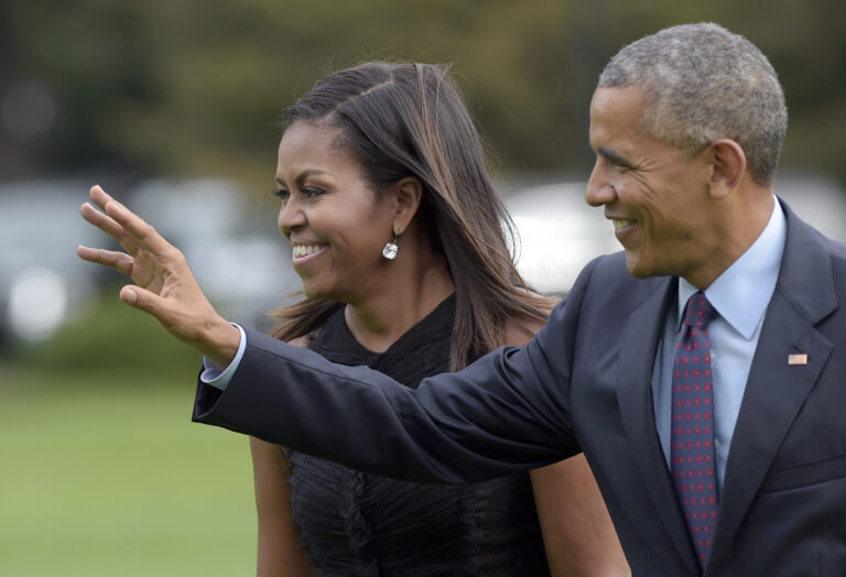President Barack Obama, with first lady Michelle Obama, waves as they walk from Marine One on the South Lawn of the White House in Washington, Wednesday, Sept. 21, 2016. The Obama's were returning from New York where the president addressed the United Nations General Assembly for his final time as president. (AP Photo/Susan Walsh) (AP)