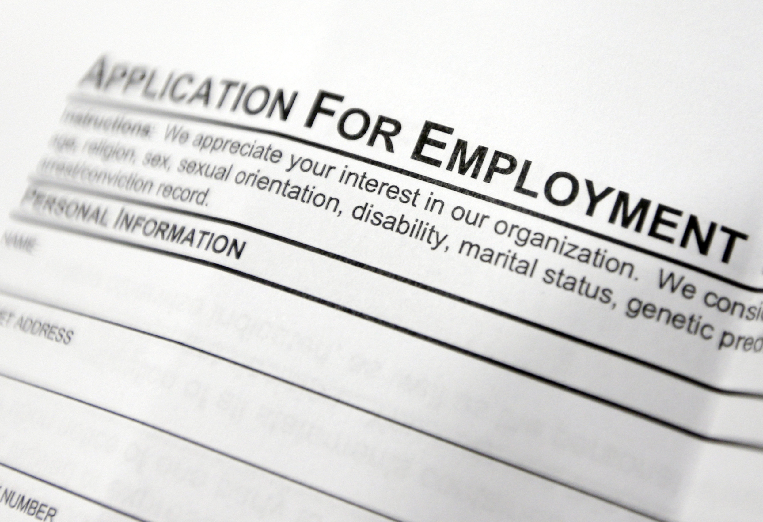 FILE - This April 22, 2014, file photo shows an employment application form on a table during a job fair at Columbia-Greene Community College in Hudson, N.Y. The Labor Department released its weekly report on applications for unemployment benefits on Thursday, Sept. 1, 2016. Slightly more Americans sought unemployment benefits during the previous week, but the overall levels still remain near historic lows in a positive sign for the job market. () (AP Photo/Mike Groll, File)