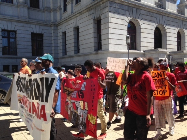 Some of the roughly 200 people who attended the Higher Ground Moral Day of Action march around the Capitol, after a rally on the buildings front steps, Monday, Sept. 12, 2016, in Harrisburg, Pa. A prominent part of their message was support for raising the minimum wage to $15 an hour, but they also advocated for action on climate change and greater use of clean energy, prison reform and union rights. (AP Photo/Mark Scolforo) (AP)