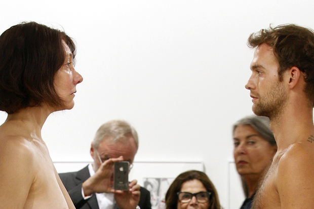 Naked performers re-perform "Imponderabilia" (1977) by artists Marina Abramovic and Ulay (Reuters/Christian Hartmann)
