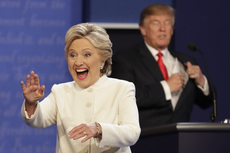 Democratic presidential nominee Hillary Clinton waves to the audience as Republican presidential nominee Donald Trump puts his notes away after the third presidential debate at UNLV in Las Vegas, Wednesday, Oct. 19, 2016. (AP Photo/John Locher) (AP)