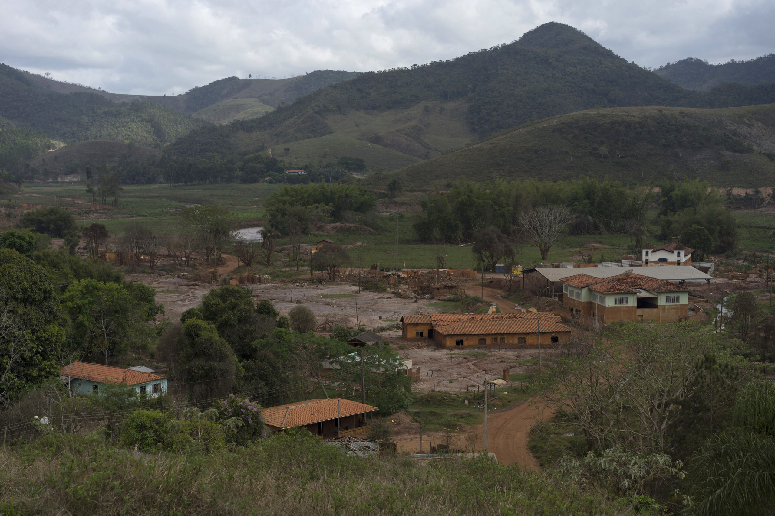 This Oct. 13, 2016 photo shows a view of the hamlet Paracatu, Brazil, destroyed by a mudslide triggered in Nov. 2015, by the failing of a dam at a nearby iron mine. On the other side of the lush mountains miles north of Rio de Janeiro, lies a valley so rich it's believed to hold one of the largest iron deposits in the planet. (AP Photo/Leo Correa) (AP)