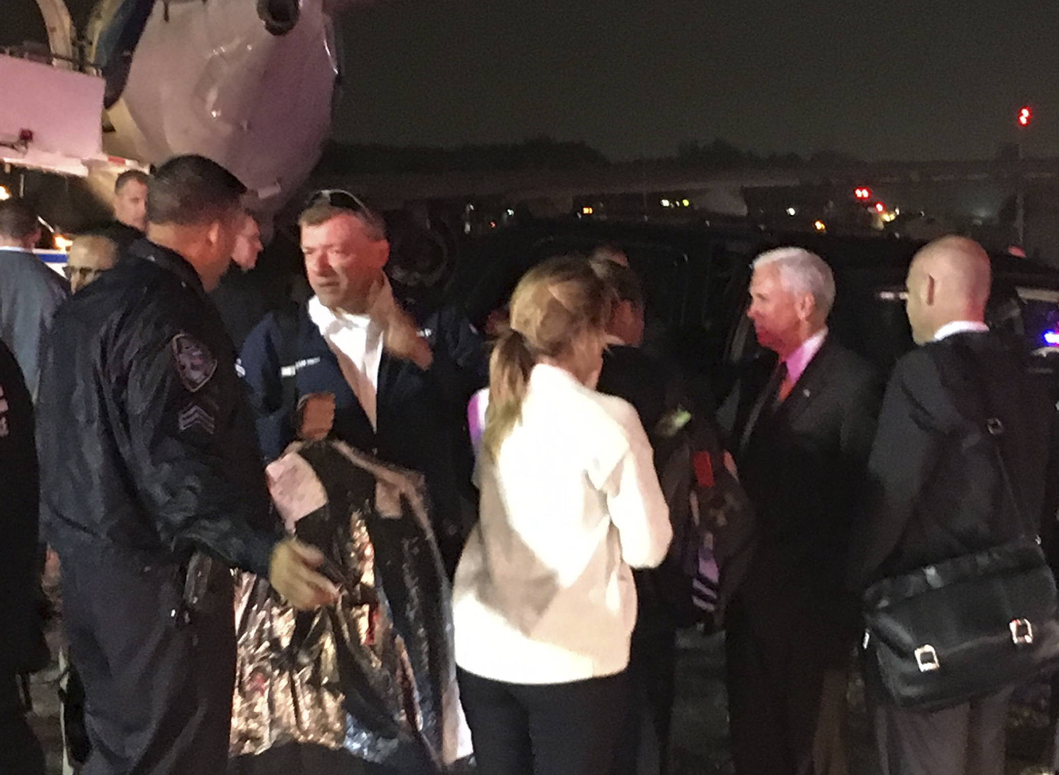 Republican vice presidential candidate Indiana Gov. Mike Pence, second from right, talks on the tarmac at New York's LaGuardia Airport after his campaign plane slide, back left, off the runway while landing on Thursday, Oct. 27, 2016. (AP Photo/Will Weissert) (AP)