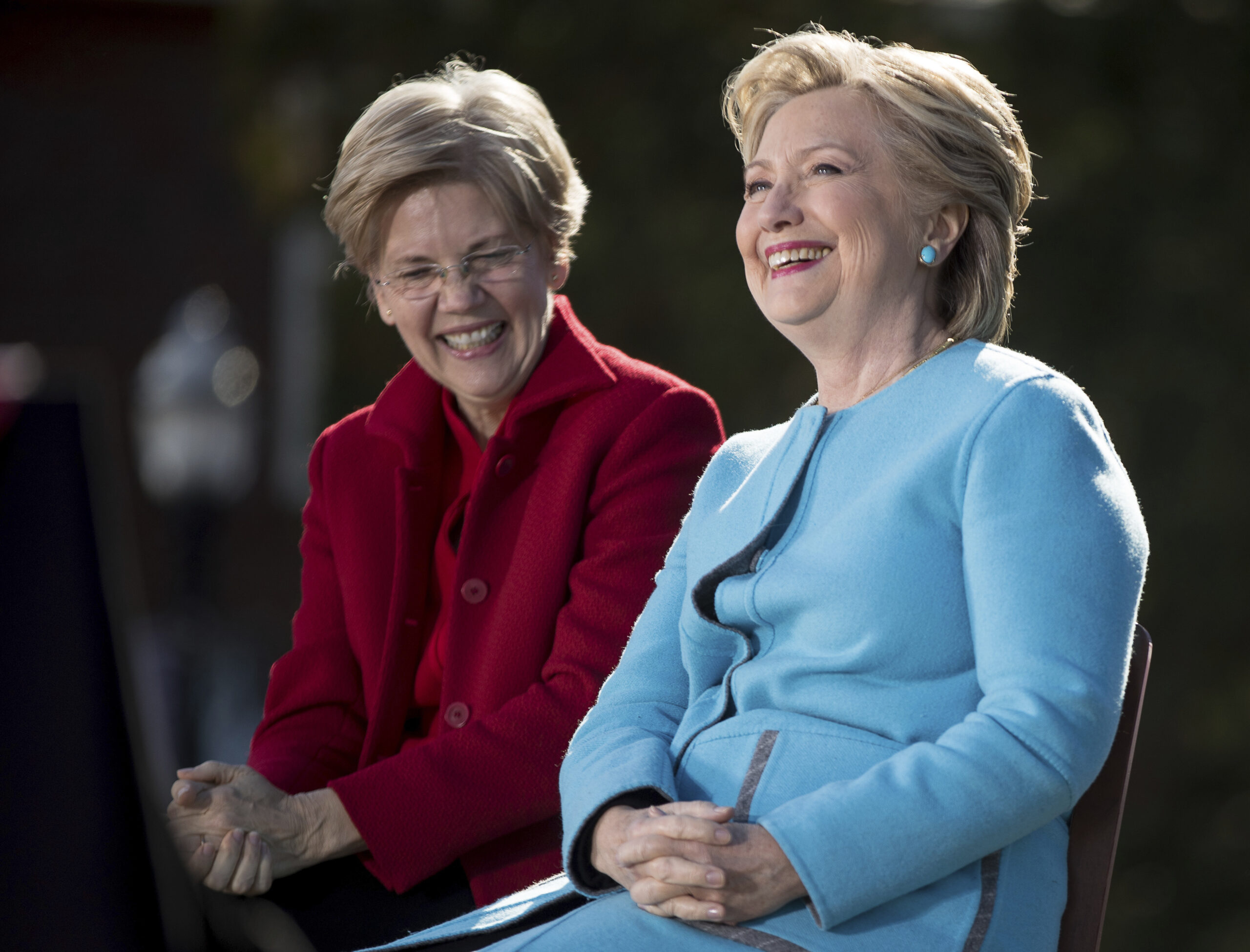 Democratic presidential candidate Hillary Clinton, accompanied by Sen. Elizabeth Warren, D-Mass., smiles as they sit on stage at a rally at St. Anselm College in Manchester, N.H., Monday, Oct. 24, 2016. (AP)