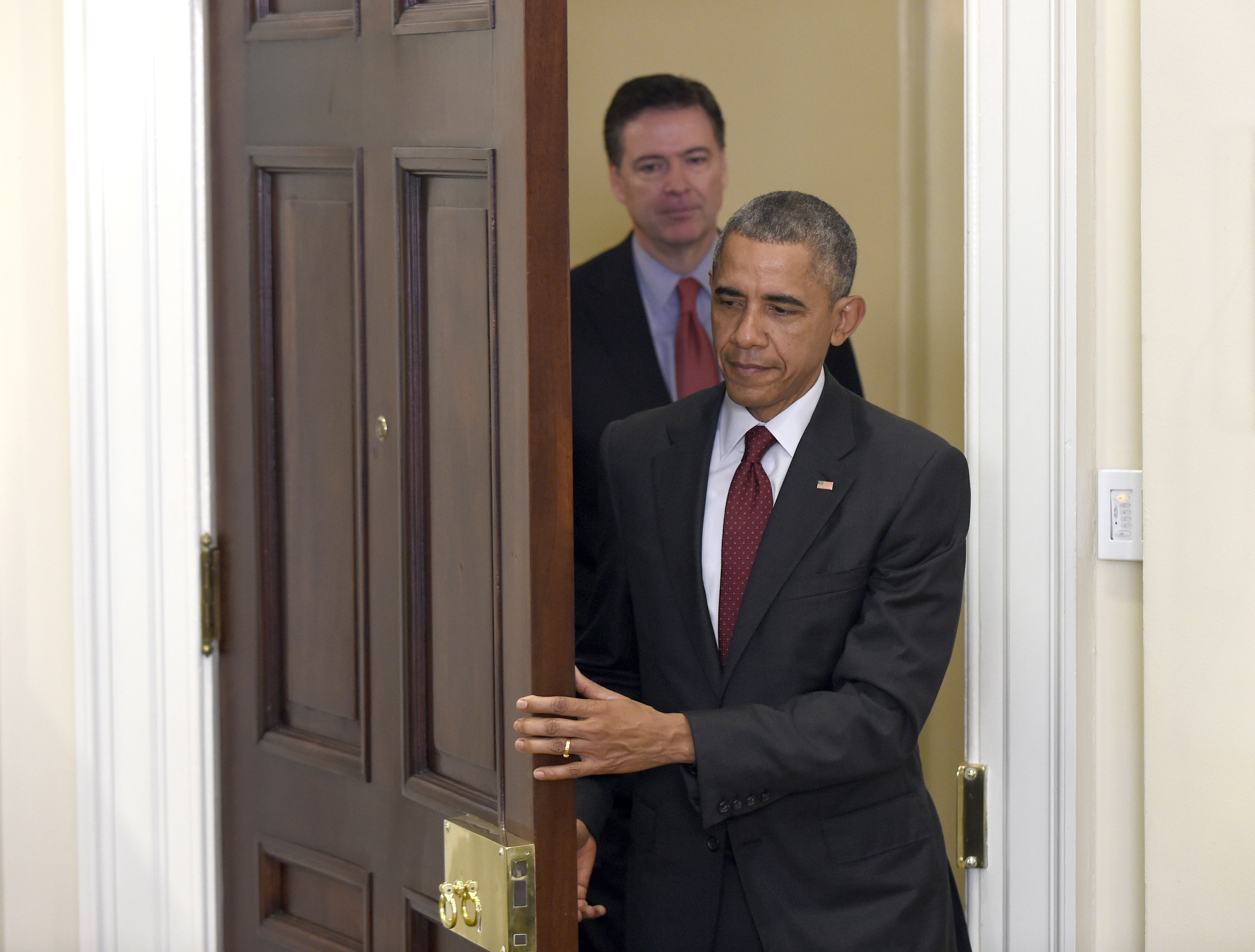 FILE - In this Nov. 25, 2015 file photo, President Barack Obama, followed by FBI Director James Comey, arrives in the Roosevelt Room of the White House in Washington to brief the public on the nation's homeland security posture heading into the holiday season, following meeting with his national security team. Comey's announcement that his bureau was reviewing new emails possibly relevant to Hillary Clinton's private email server investigation has thrust him into the public spotlight again just days before Election Day. (AP Photo/Susan Walsh, File) (AP)