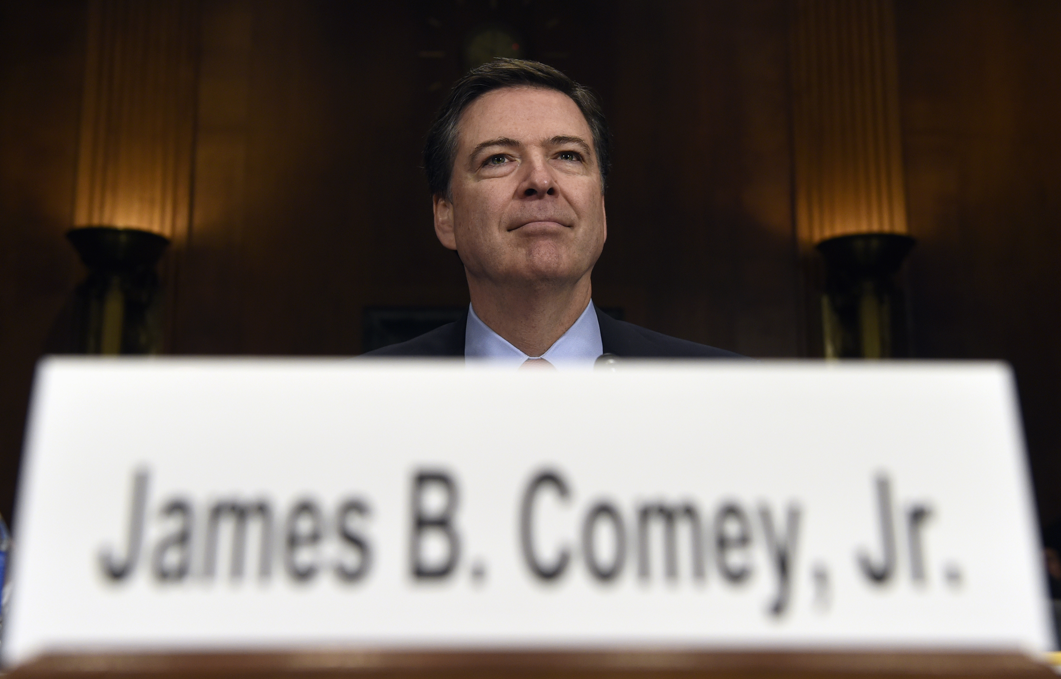 FILE - In this Dec. 9, 2015 file photo, FBI Director James Comey prepares to testify on Capitol Hill in Washington. Comey's announcement that his bureau was reviewing new emails possibly relevant to Hillary Clinton's private email server investigation has thrust him into the public spotlight again just days before Election Day.  (AP Photo/Susan Walsh, File) (AP)