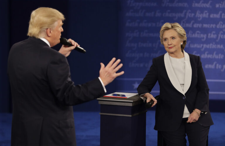 Democratic presidential nominee Hillary Clinton listens to Republican presidential nominee Donald Trump during the second presidential debate at Washington University in St. Louis, Sunday, Oct. 9, 2016. (AP Photo/John Locher) (AP)