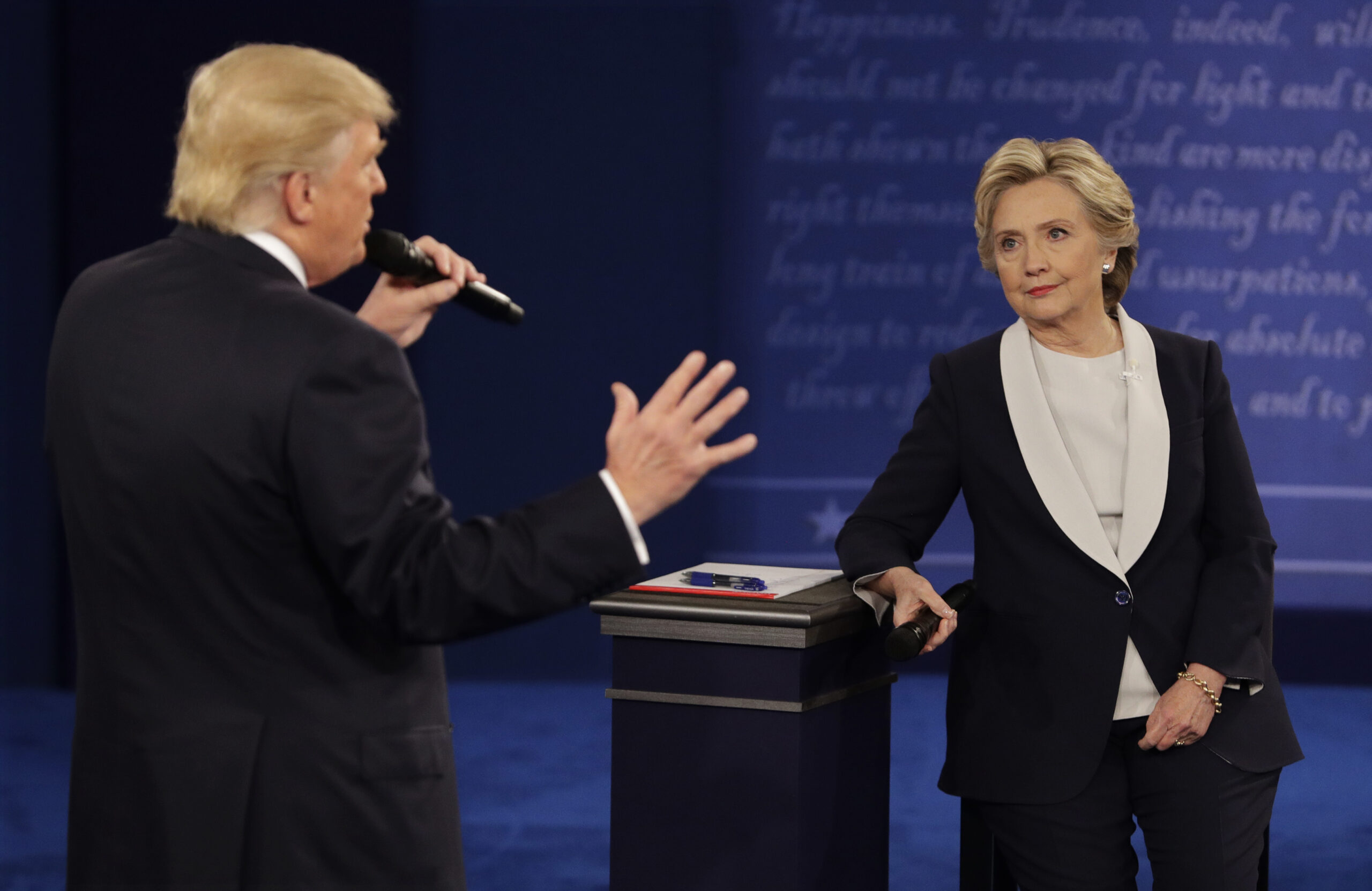 Democratic presidential nominee Hillary Clinton listens to Republican presidential nominee Donald Trump during the second presidential debate at Washington University in St. Louis, Sunday, Oct. 9, 2016. (AP Photo/John Locher) (AP)