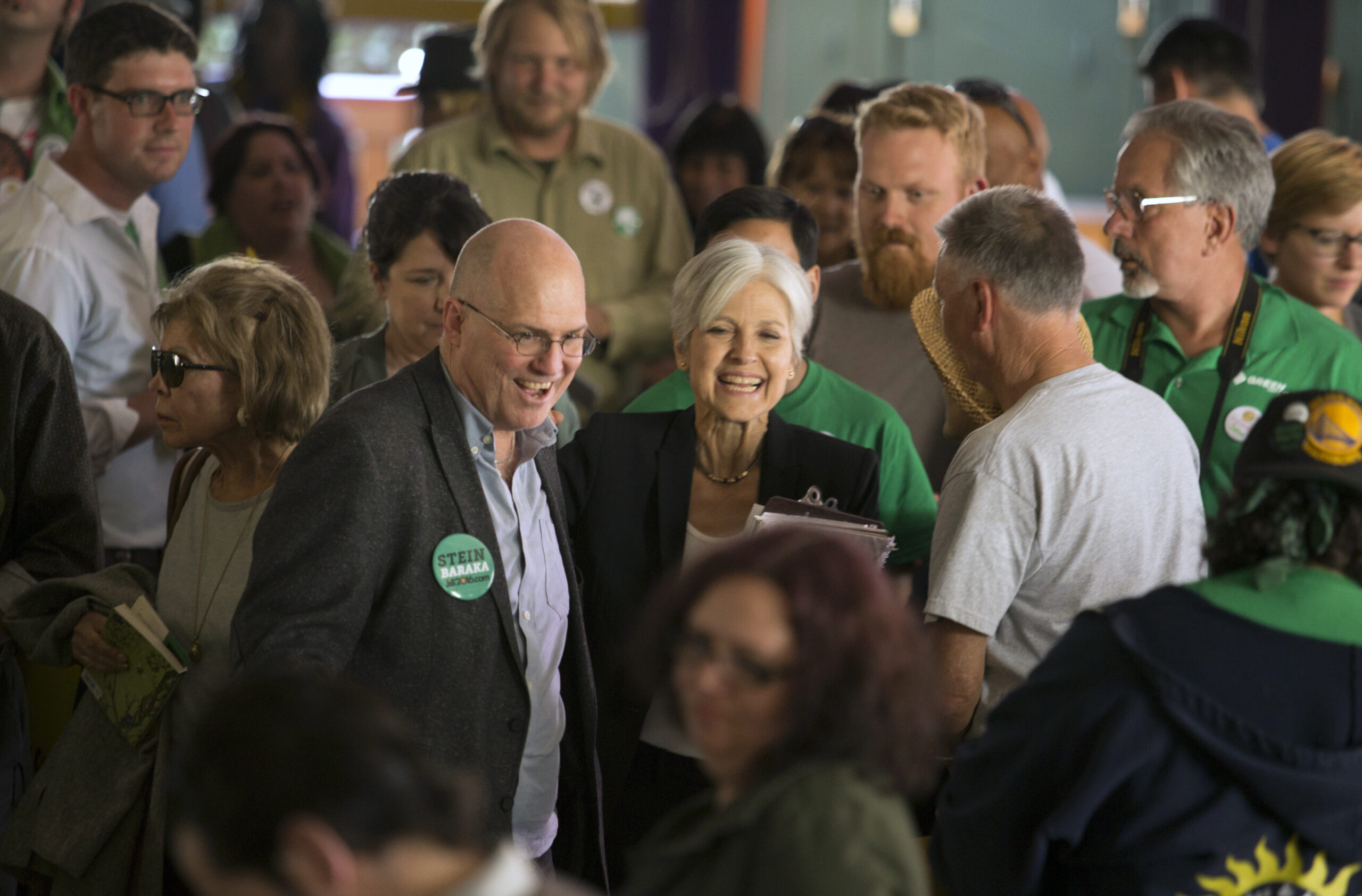 Accompanied by 2004 presidential candidate David Cobb, left, Green party presidential hopeful Jill Stein meets her supporters during a campaign stop at Humanist Hall in Oakland, Calif. (AP)