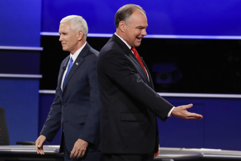 Republican vice-presidential nominee Gov. Mike Pence and Democratic vice-presidential nominee Sen. Tim Kaine, right, walk past each other after the vice-presidential debate at Longwood University in Farmville, Va., Tuesday, Oct. 4, 2016. (AP Photo/David Goldman) (AP)
