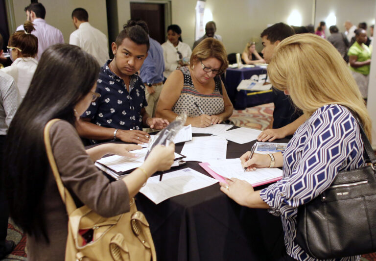 FILE - In this July 19, 2016, file photo, people fill out job applications at a job fair in Miami Lakes, Fla. Tepid income growth and shrinking opportunities for blue-collar workers have kept many Americans anxious about jobs and the economy, seven years after the Great Recession ended. The unemployment rate has fallen to a relatively low 4.9 percent. But many Americans are struggling to keep up with an economy that has been fundamentally transformed since the recession, and is very different from the one their parents experienced. (AP Photo/Lynne Sladky, File) (AP Photo/Lynne Sladky)