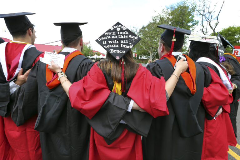 FILE - In this May 15, 2016 file photo, students embrace as they arrive for the Rutgers graduation ceremonies in Piscataway, N.J.  More Americans are getting buried by student debt, causing delays in home ownership, limiting how much people can save and leaving taxpayers at risk as many loans go unpaid. (AP Photo/Mel Evans) (AP)