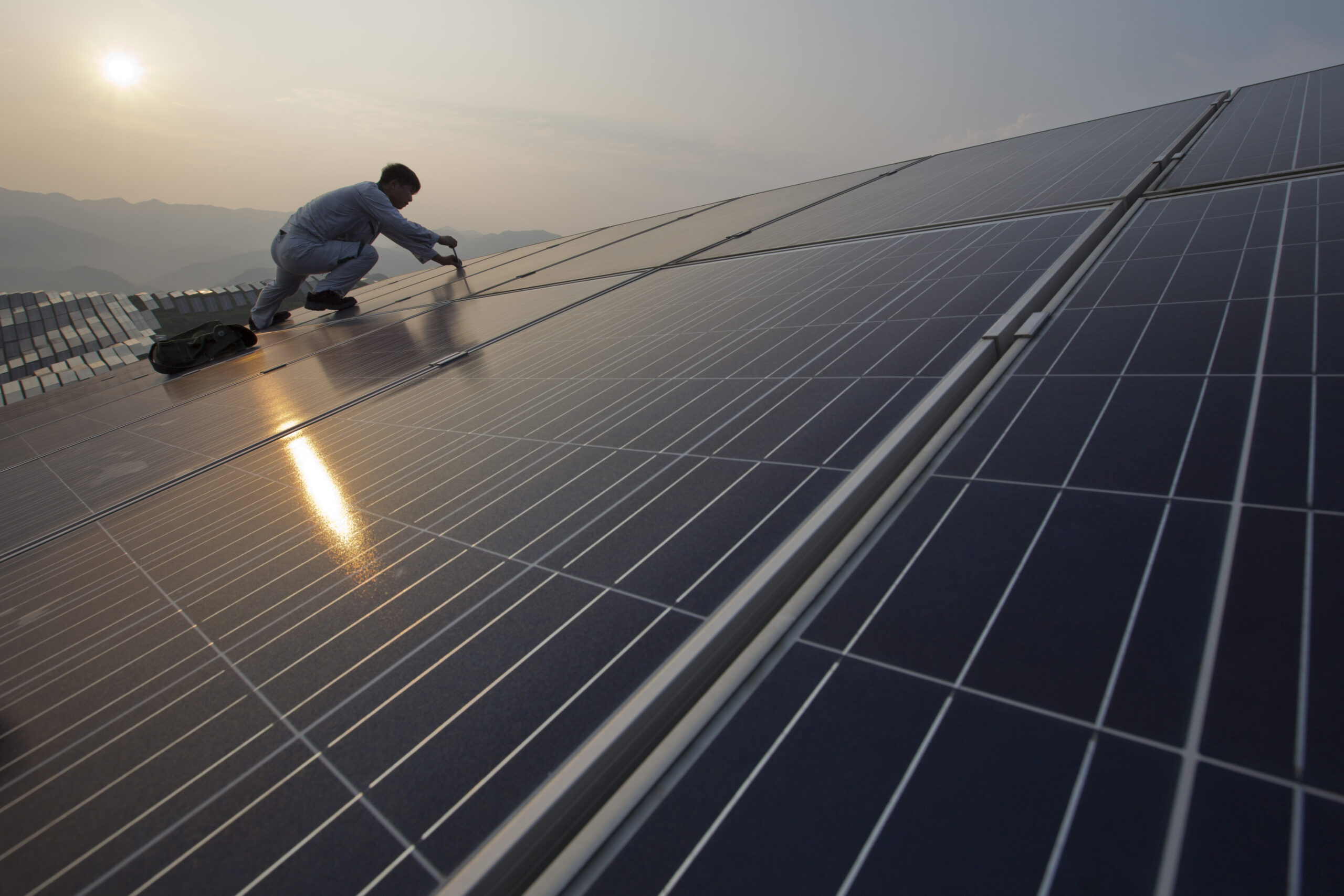 In this Aug. 21, 2016 photo, a worker performs maintenance work on solar panels at a photovoltaic power station in Songxi county in southeast China's Fujian province. Solar panels are among a series of industries from steel and cement to wind turbines in which Chinese production capacity soared during the past decade's economic boom until it vastly exceeded demand. (Chinatopix via AP) (AP)