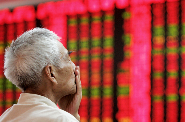 A Chinese investor looks at a stock price chart (AP/Eugene Hoshiko)