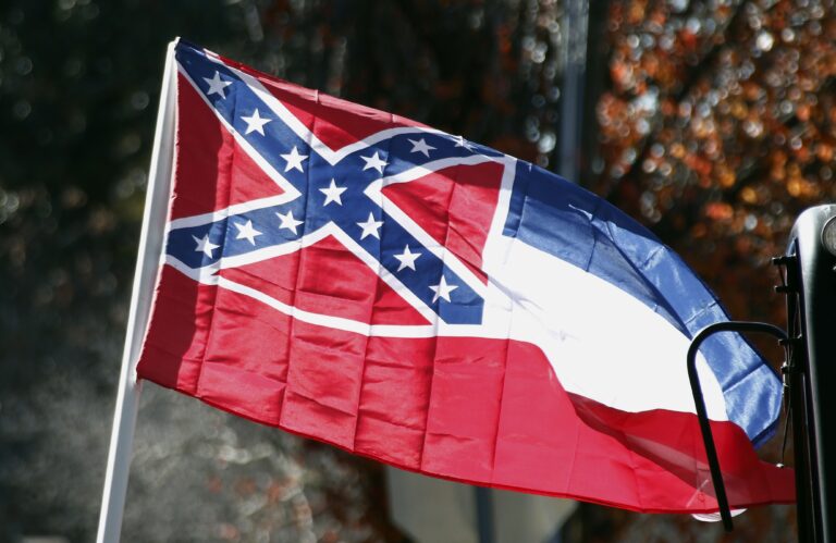 FILE - In this Tuesday, Jan. 19, 2016 file photo, a state flag of Mississippi is unfurled by Sons of Confederate Veterans and other groups on the grounds of the state Capitol in Jackson, Miss.An effort to erase the Confederate battle emblem from the Mississippi flag is failing because sponsors didn't gather enough signatures to put an initiative on the 2018 ballot. (AP Photo/Rogelio V. Solis, File) (AP)