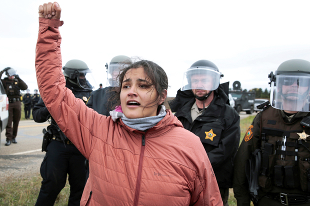 Ta'Sina Sapa Win of South Dakota's Cheyenne River Reservation chants in front of police during a protest against the Dakota Access Pipeline outside Saint Anthony, North Dakota, October 5, 2016. (Reuters/Terray Sylvester)