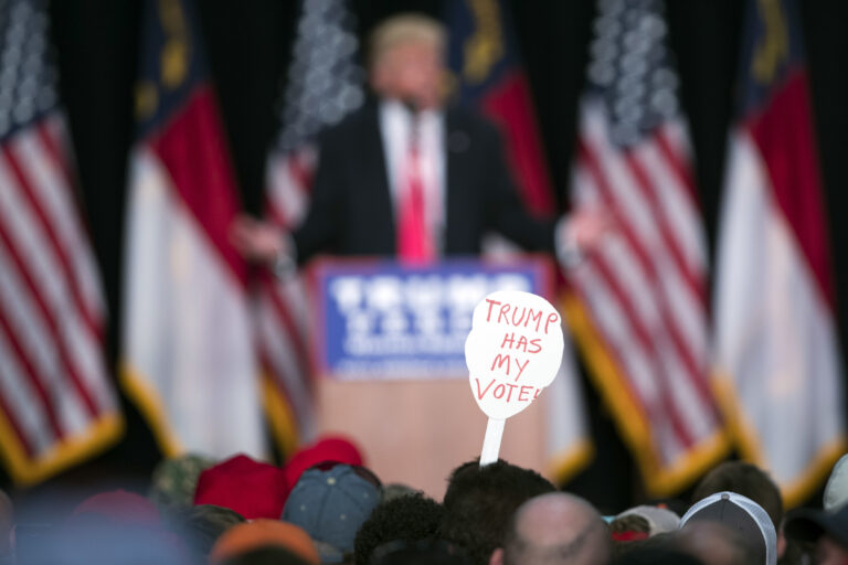 FILE - In this Monday, July 25, 2016 file photo, a supporter of Republican presidential candidate Donald Trump holds a sign during a campaign rally in Winston-Salem, N.C. A Kaiser Family Foundation-CNN poll released in September 2016 compared white college graduates and the white, black and Hispanic working class. Working-class whites were least likely to say that they're satisfied with their influence in the political process, that the federal government represents their views, and that they believe their children will achieve a better standard of living than themselves. (AP Photo/Evan Vucci) (AP)