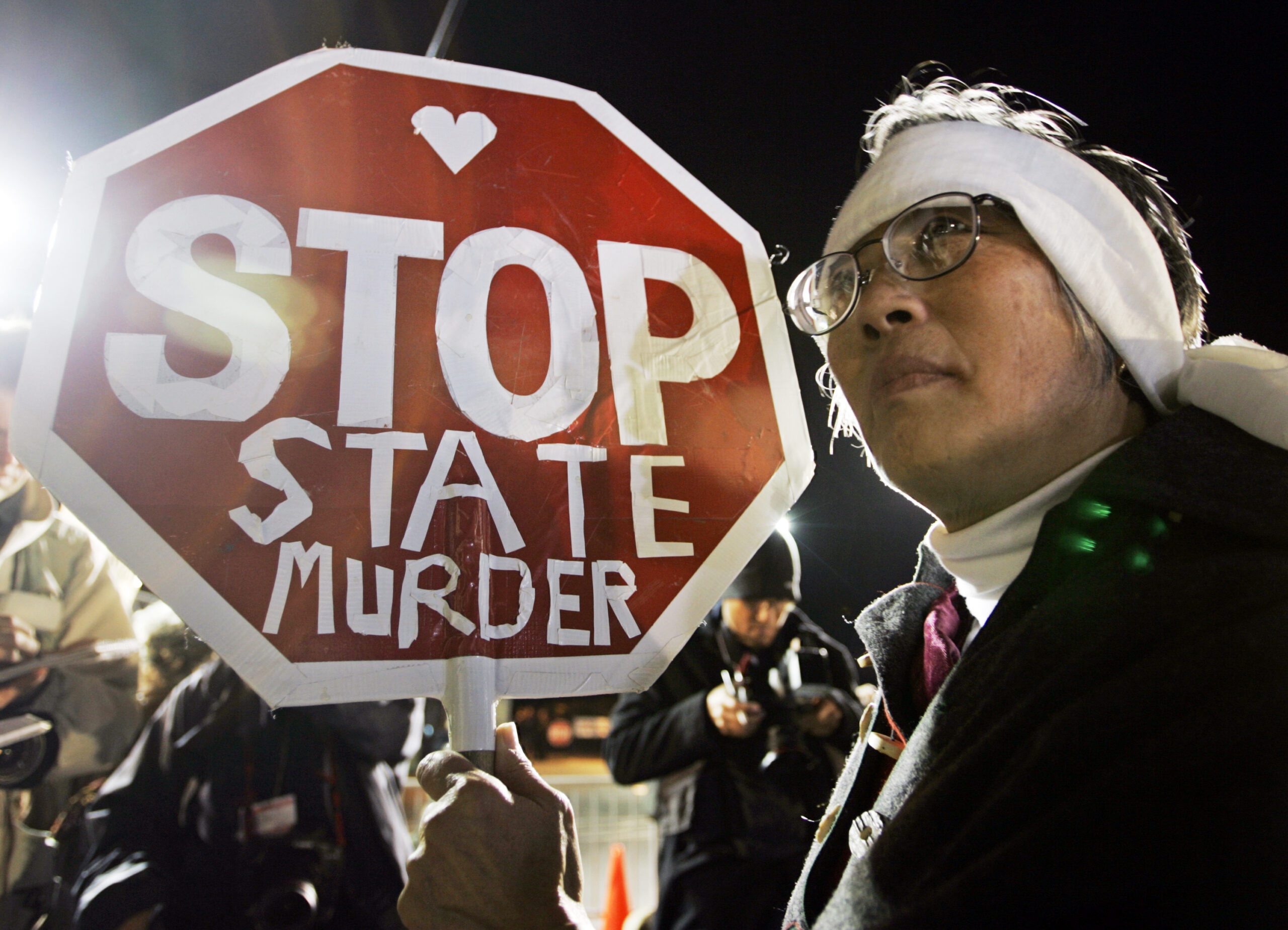 FILE - In this Dec. 12, 2005, file photo, Barbara Chan protests the execution of Stanley "Tookie" Williams, the founder of the Crips gang, outside of San Quentin State Prison in San Quentin, Calif. Williams was executed early Dec. 13. California voters face opposite choices to fix the state's broken death penalty. They can repeal capital punishment in November or reform it so convicted murderers are actually executed. (AP Photo/Eric Risberg, File) (AP)