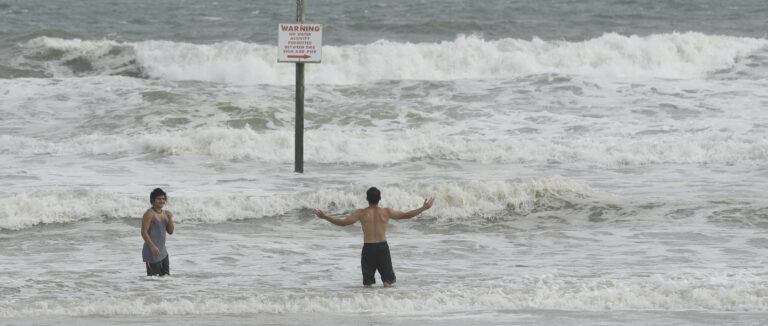 A pair of swimmers take advantage of the high surf from winds associated with Hurricane Matthew Thursday, Oct. 6, 2016, in Daytona Beach, Fla. (AP)