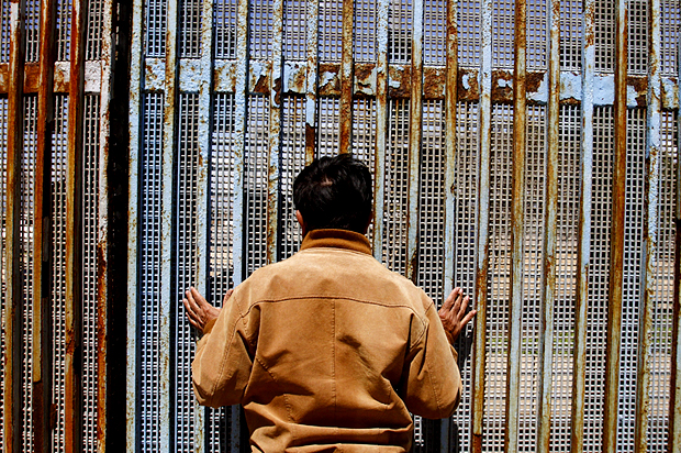 A man talks to a relative at a wall separating Mexico and the United States (Reuters/Jorge Duenes)