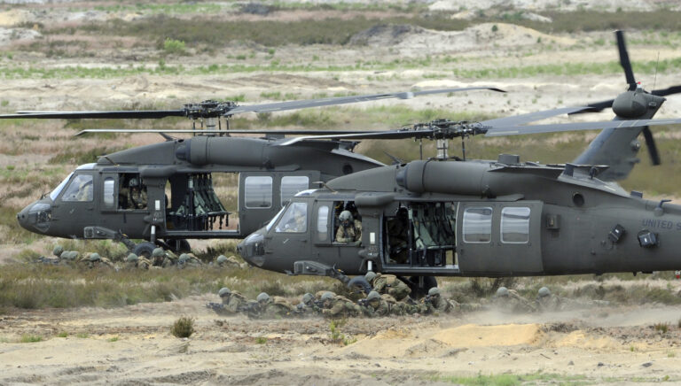 FILE -- In this June 18, 2015 file photo U.S. Army Black Hawk helicopters support soldiers during the NATO Noble Jump exercise on a training range near Swietoszow Zagan, Poland. Polish leaders say the country is buying Polish-made Black Hawk helicopters as it modernizes the army. The announcement comes days after Poland scrapped plans to buy 50 French-made military helicopters from Airbus Helicopters for 3.14 billion euros (US dollar 3.5 billion). (AP Photo/Alik Keplicz, file) (AP)