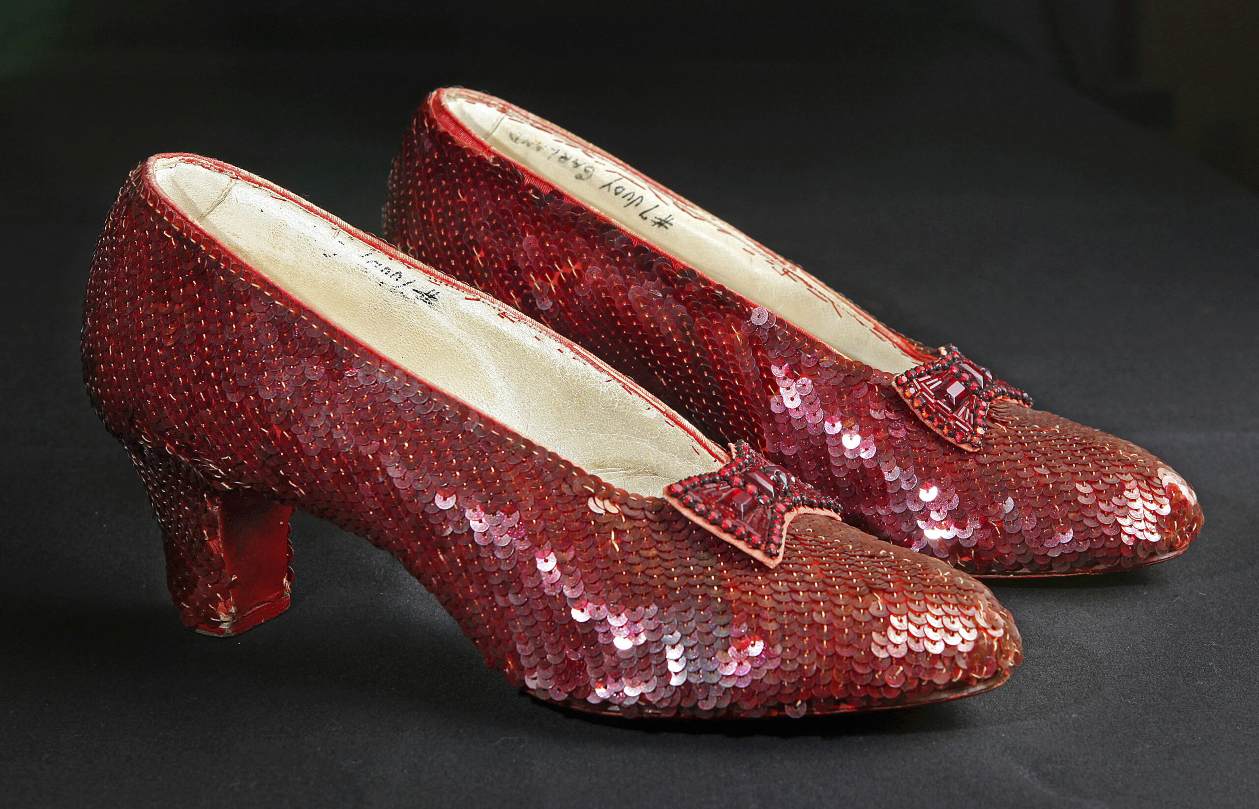 File- This Nov. 9, 2001, file photo shows the sequin-covered ruby slippers worn by Judy Garland in "The Wizard of Oz"  at the offices of Profiles in History in Calabasas, Calif. Smithsonian Museum officials started a Kickstarter fundraising drive Monday, Oct. 17, 2016,  to repair the iconic slippers from 1939’s “The Wizard of Oz” and create a new state-of-the-art display case for them at the National Museum of American History.  (AP Photo/Reed Saxon, File) (AP)