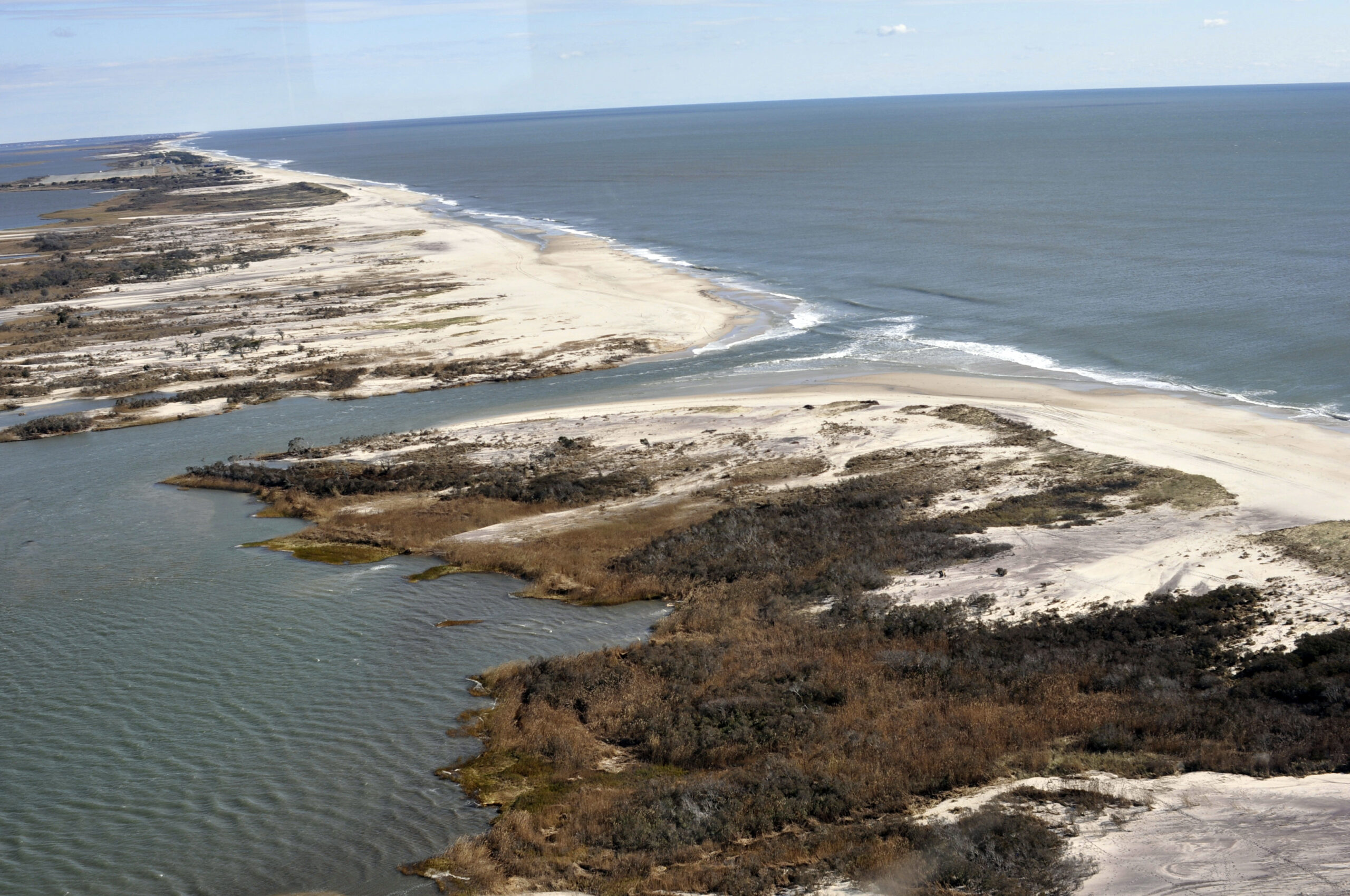 This Nov. 3, 2012 aerial photo provided by the National Park Service, taken off Bellport, N.Y., the week after Superstorm Sandy, shows an opening, center, that was created by the storm in the eastern strip of Fire Island that separates the Atlantic Ocean, upper right, from the Great South Bay.  (USGS Cheryl Hapke/National Park Service via AP) (AP)