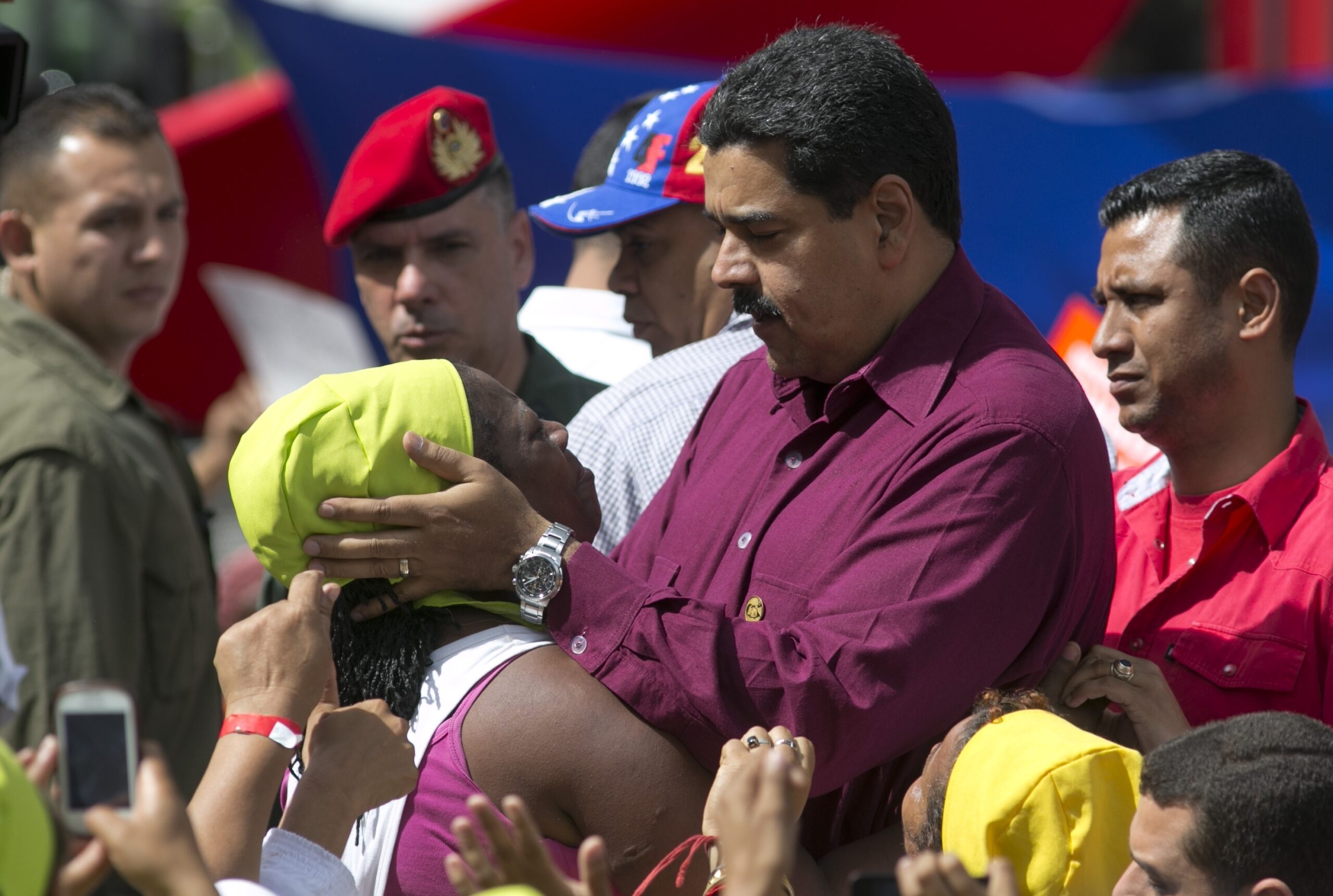 Venezuela's President Nicolas Maduro listens to a supporter during a rally outside Miraflores presidential palace in Caracas, Venezuela, Friday, Oct. 28, 2016. For the most part, residents of Venezuela's capital ignored calls to stay home Friday to protest Maduro, handing a rare victory to the embattled leader. (AP Photo/Ariana Cubillos) (AP)
