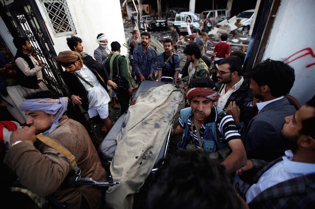 Yemenis carry the body of a man killed in a Saudi-led coalition airstrike on mourners at a funeral hall in Sana'a, Yemen on Saturday, October 8, 2016 (Reuters/Khaled Abdullah)