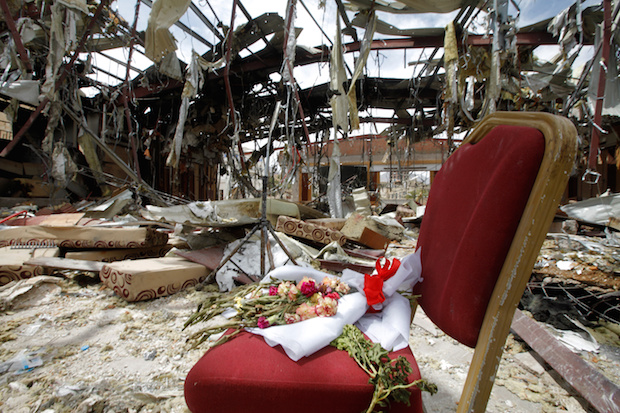 Flowers on a chair in the ruins of a community hall that the U.S.-backed, Saudi-led coalition bombed during a funeral on October 8, in Sanaa, Yemen, October 16, 2016 (Reuters/Mohamed al-Sayaghi)