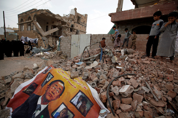 A defaced poster of the U.N. Secretary-General Ban Ki-moon on the rubble of a house during a vigil marking one year since a Saudi-led airstrike on a residential area in Yemens capital Sana'a, June 21, 2016 (Reuters/Khaled Abdullah)