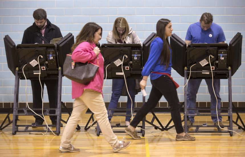 Voters in Ohio, 2015. (AP Photo/John Minchillo, File)