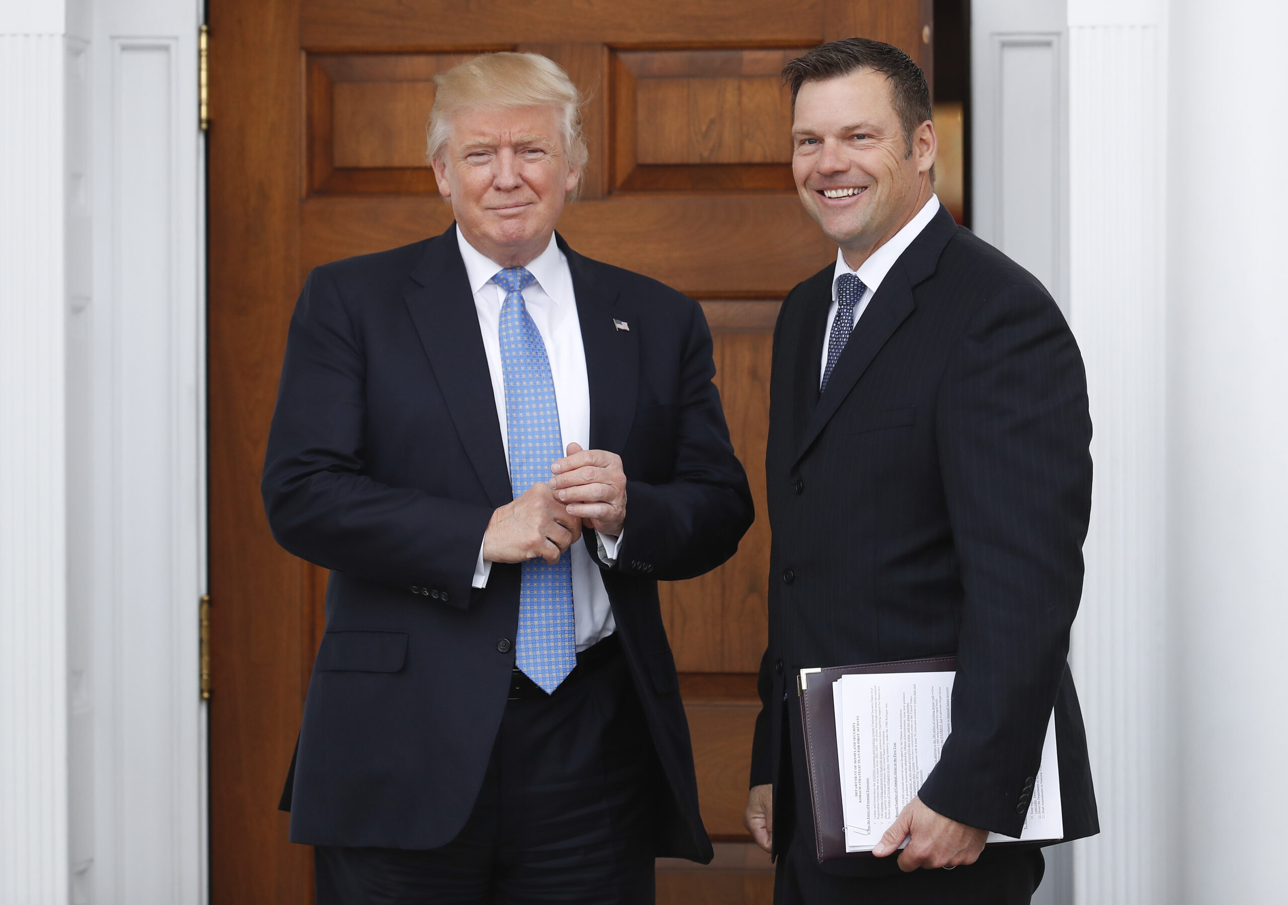 President-elect Donald Trump pauses pose for photographs as he greets Kansas Secretary of State, Kris Kobach, at the Trump National Golf Club Bedminster clubhouse, Sunday, Nov. 20, 2016, in Bedminster, N.J.. () (AP Photo/Carolyn Kaster)