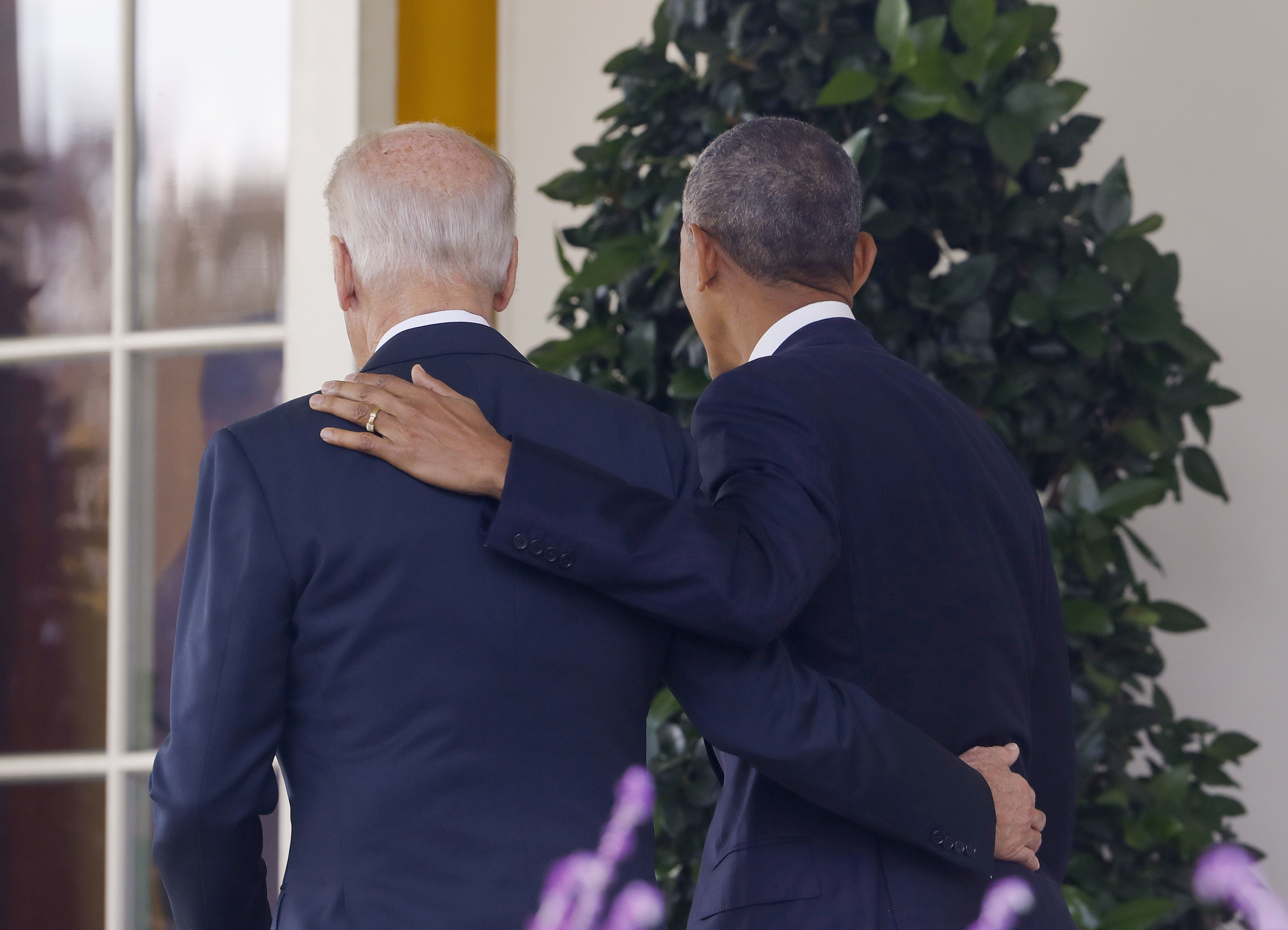 President Barack Obama and Vice President Joe Biden, with their arms on each other, walk back to the Oval Office of the White House in Washington, Wednesday, Nov. 9, 2016, after the president spoke about the election in the Rose Garden. (AP)