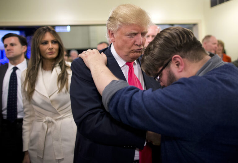 FILE - In this Jan. 31, 2016, file photo, Pastor Joshua Nink, right, prays for Republican presidential candidate Donald Trump, as his wife, Melania, left, watches after a Sunday service at First Christian Church, in Council Bluffs, Iowa. (AP)