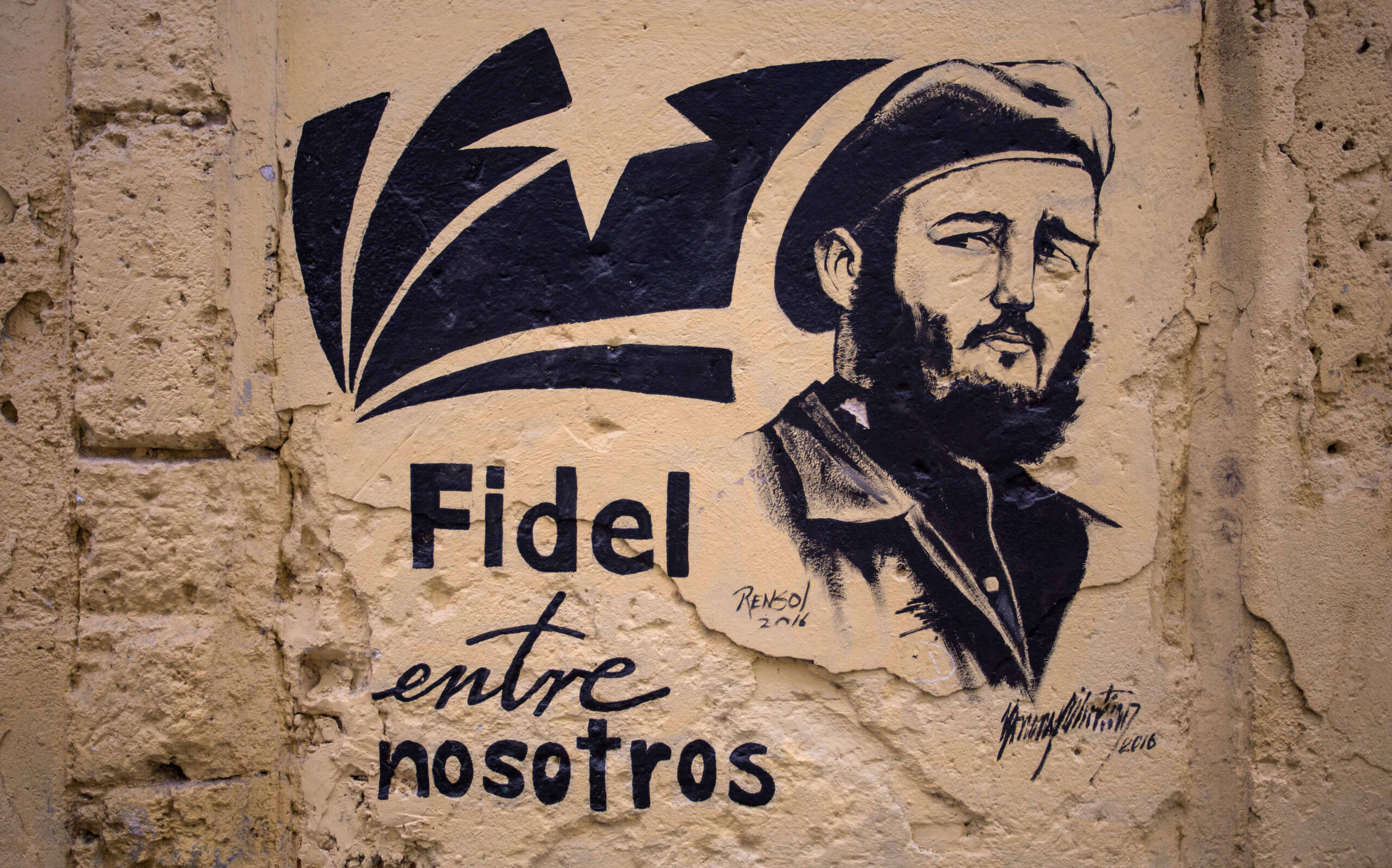 A stencil graffiti featuring Fidel Castro's image says in Spanish "Fidel among us," in an alleyway in Havana, Cuba, Sunday, Nov. 27, 2016. (AP)