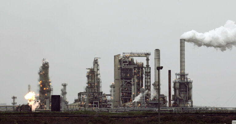 FILE - This April 2, 2010 file photo shows a Tesoro Corp. refinery, including a gas flare flame that is part of normal plant operations, in Anacortes, Wash. In the 2016 election, voters in Washington state rejected an initiative that would have taxed carbon emissions from fossil fuels such as coal and gasoline. () (AP Photo/Ted S. Warren, File)