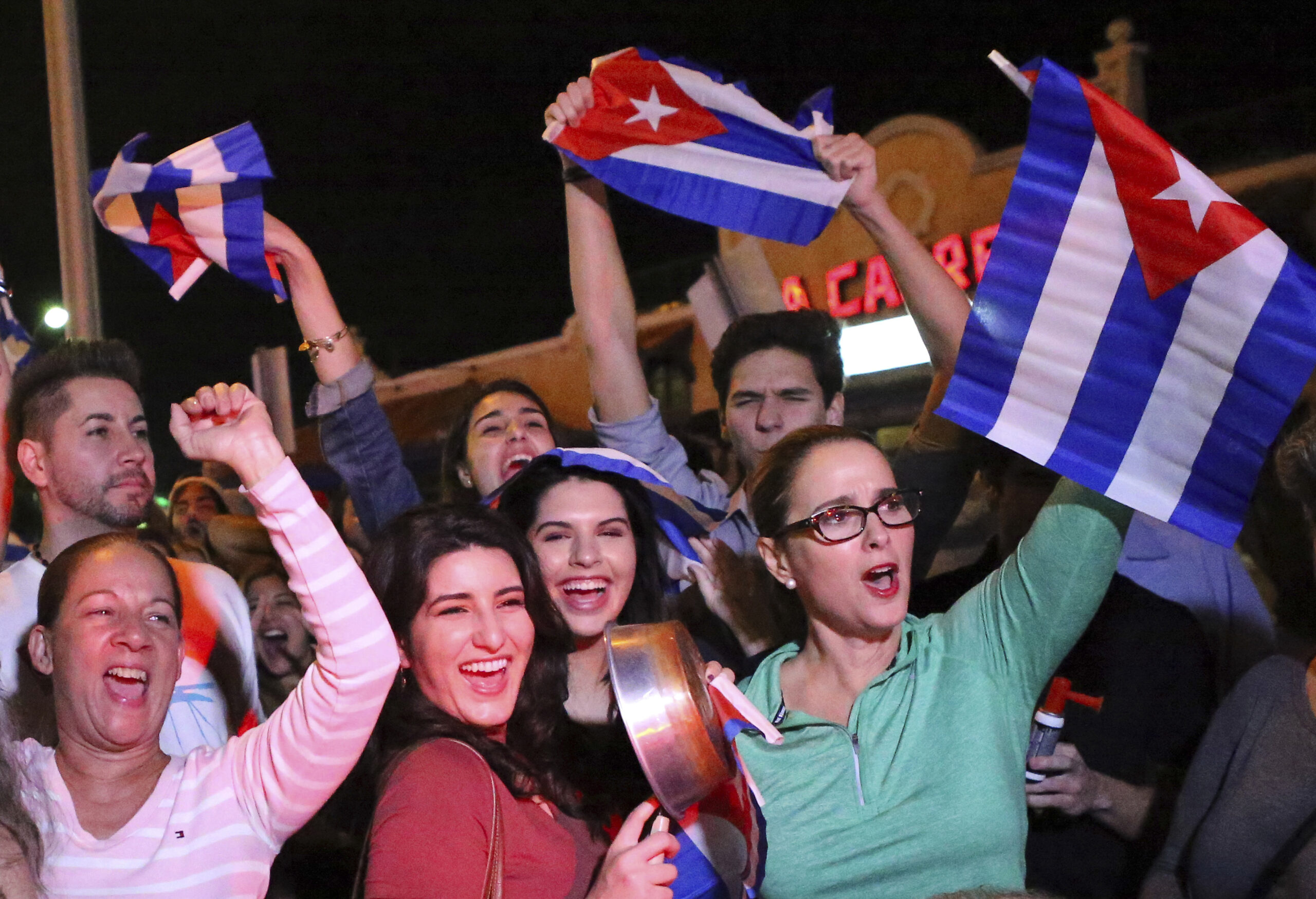 FILE- In this Nov. 25, 2016, file photo, the Cuban community in Miami celebrates the announcement that Fidel Castro died in front La Carreta Restaurant early in Miami. For the hundreds of thousands of children born of Cuban exiles, some who are two and three generations removed from the island, Fidel Castro’s death potentially opens a door to a world previously off-limits. (David Santiago/El Nuevo Herald via AP, File) (AP)